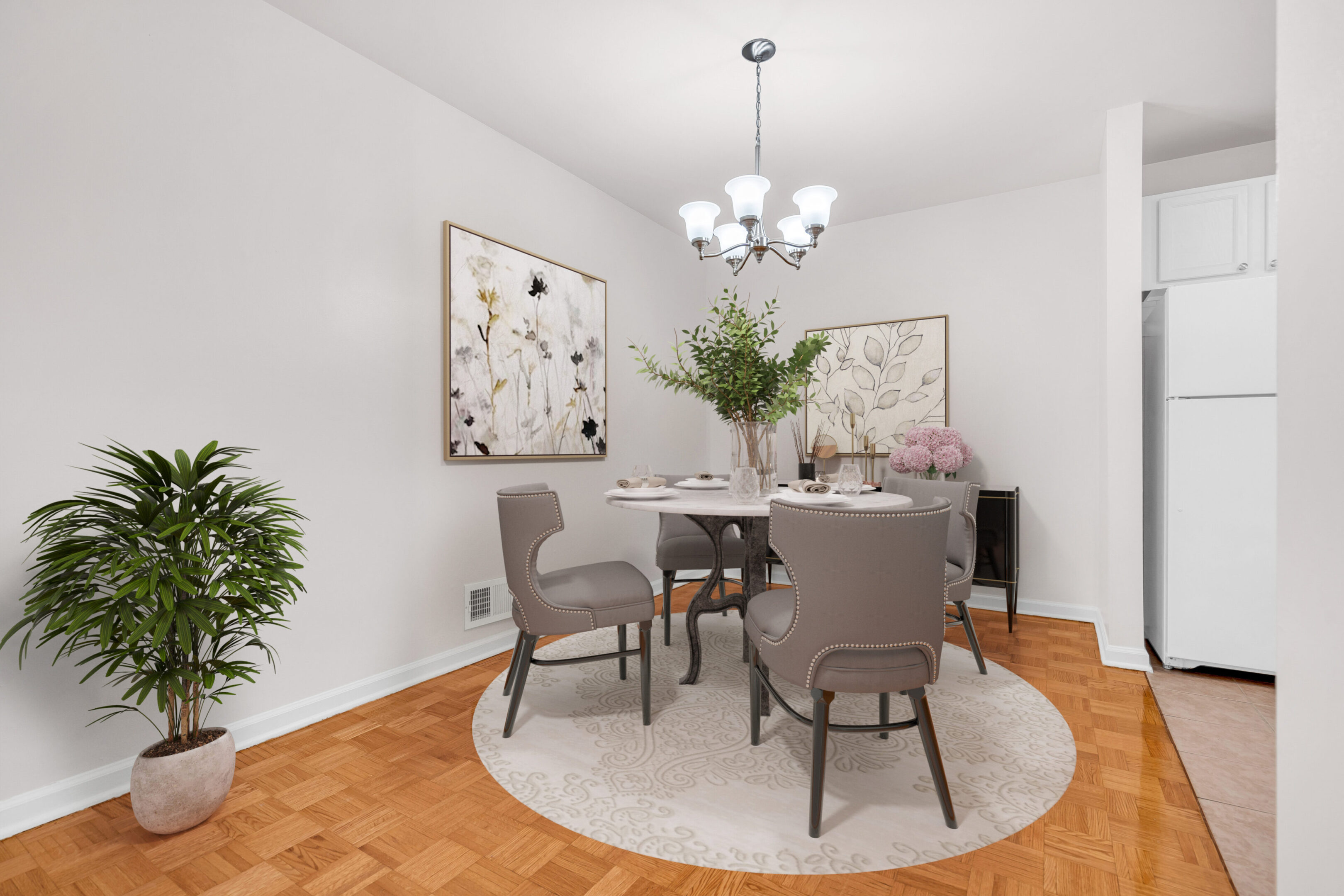 A dining room with four chairs and a table