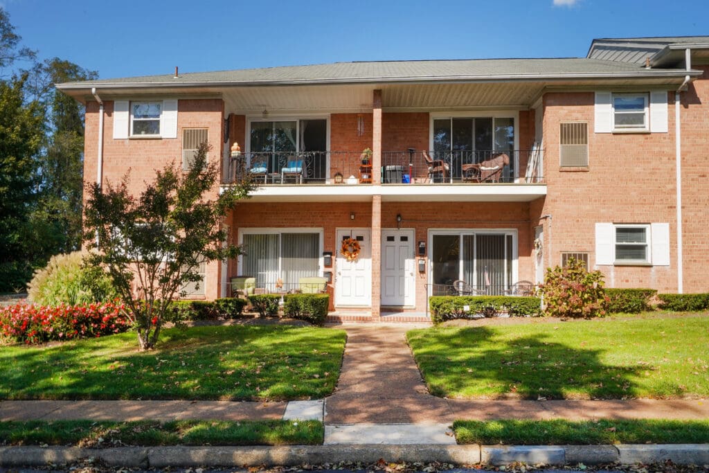 A brick building with two balconies and a porch.