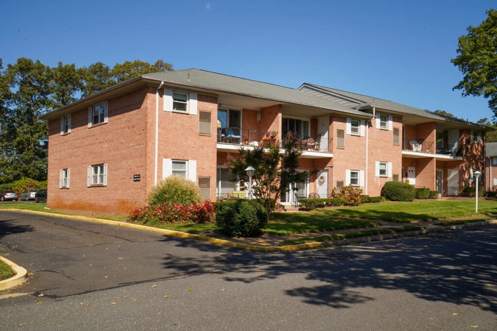 A brick building with trees in front of it.