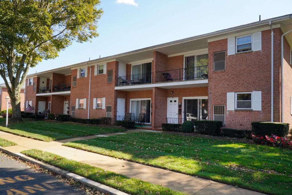 A row of brick buildings on the side of a street.