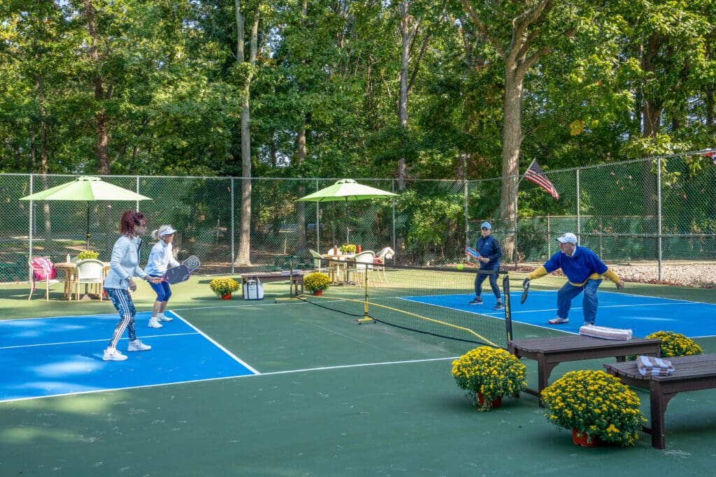 A group of people playing tennis on the court