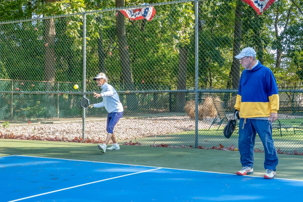 A man and woman playing tennis on the court.