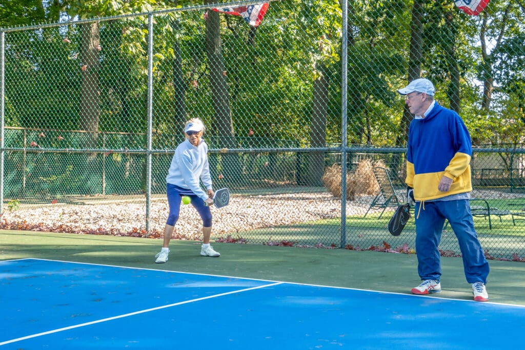 A man and woman playing tennis on the court