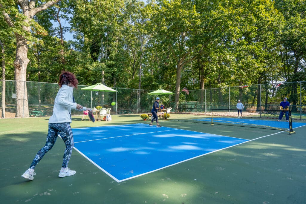 A woman is playing tennis on the court