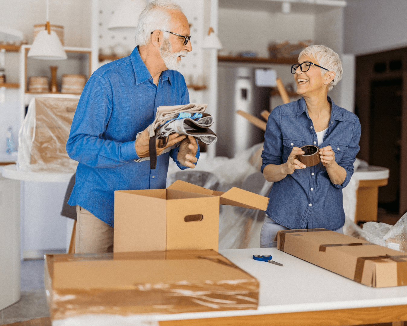 A man and woman are looking at boxes.